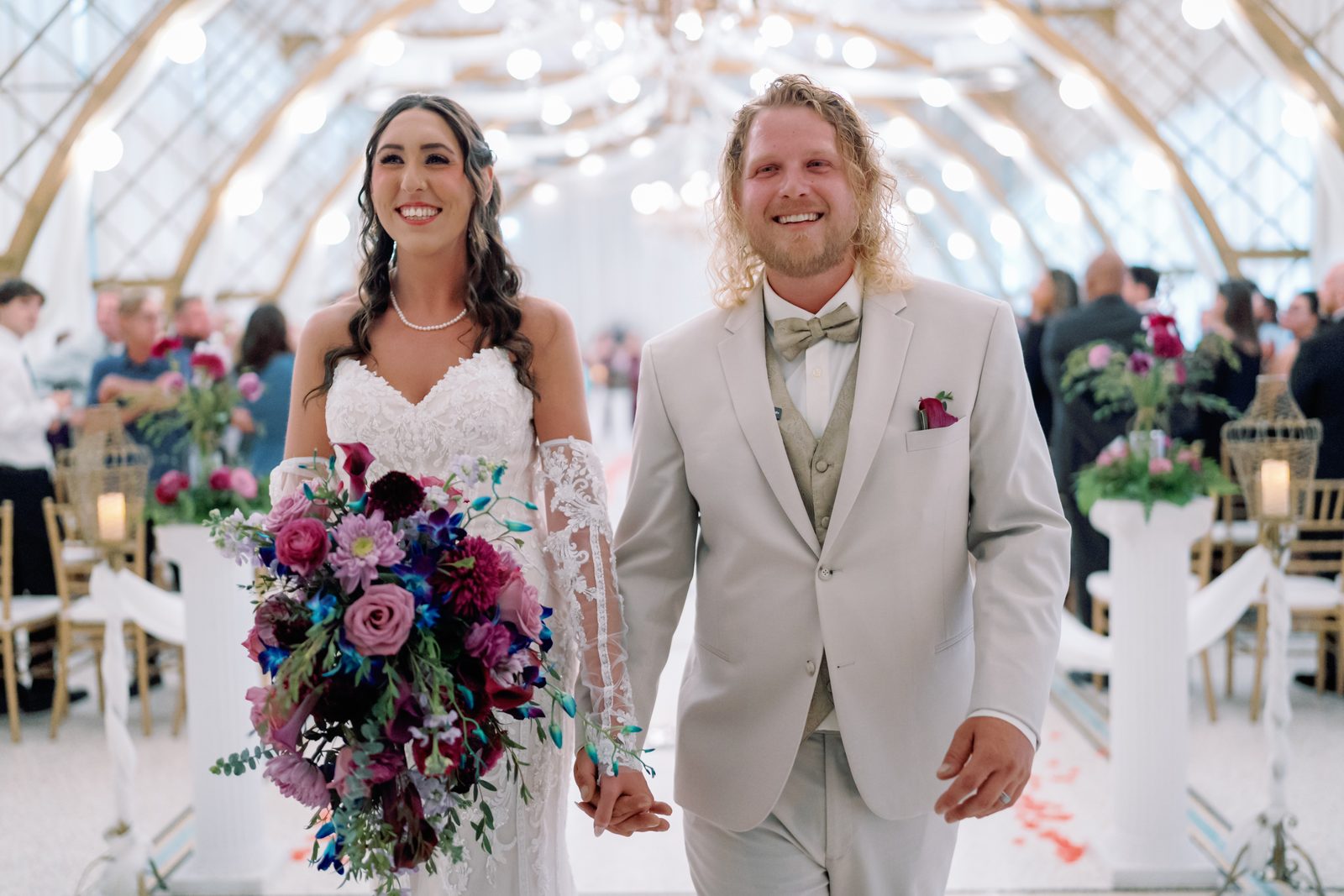 The couple walking back down the aisle after the ceremony